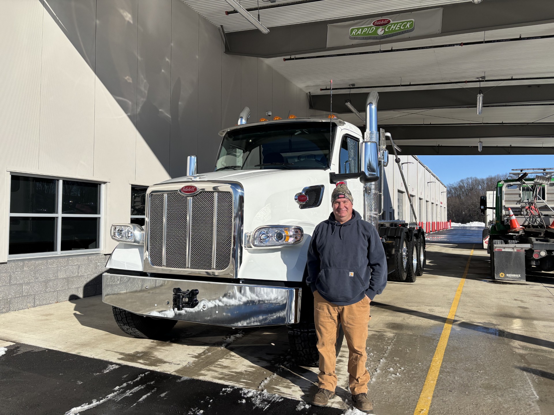 Ricky Bamber, owner of B&B Disposal, in front of a B&B roll-off truck at the yard